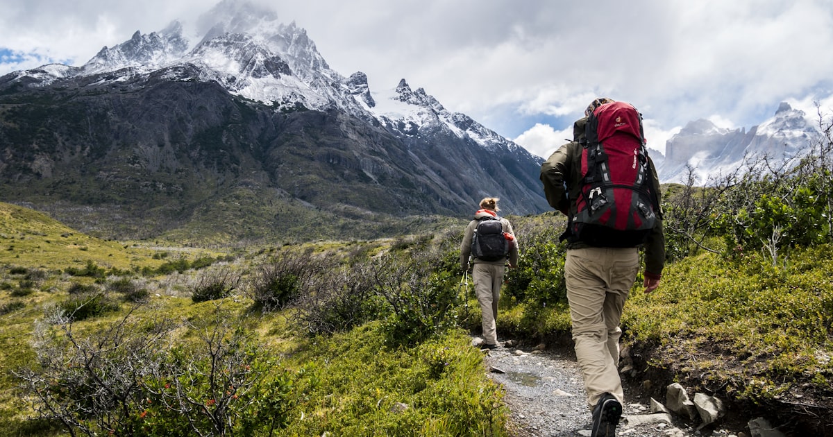 Person reaching the summit, representing the achievement of financial independence