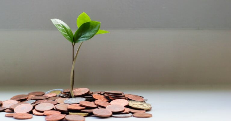 Coins and a jar representing savings and financial growth