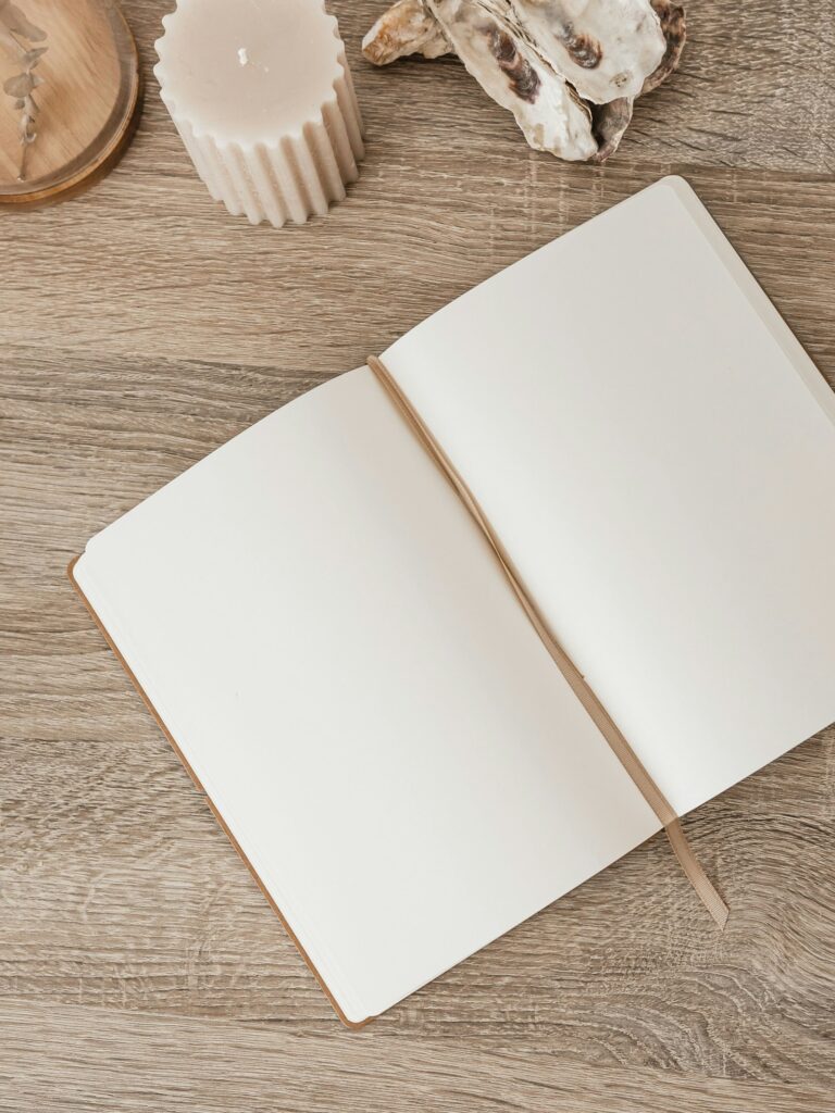 An open notebook used for financial journaling and a money journal to track spending and goals