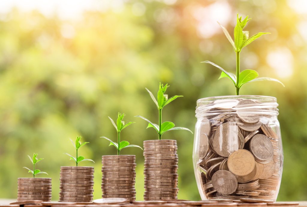 Stacked coins growing into a passive income stream over time
