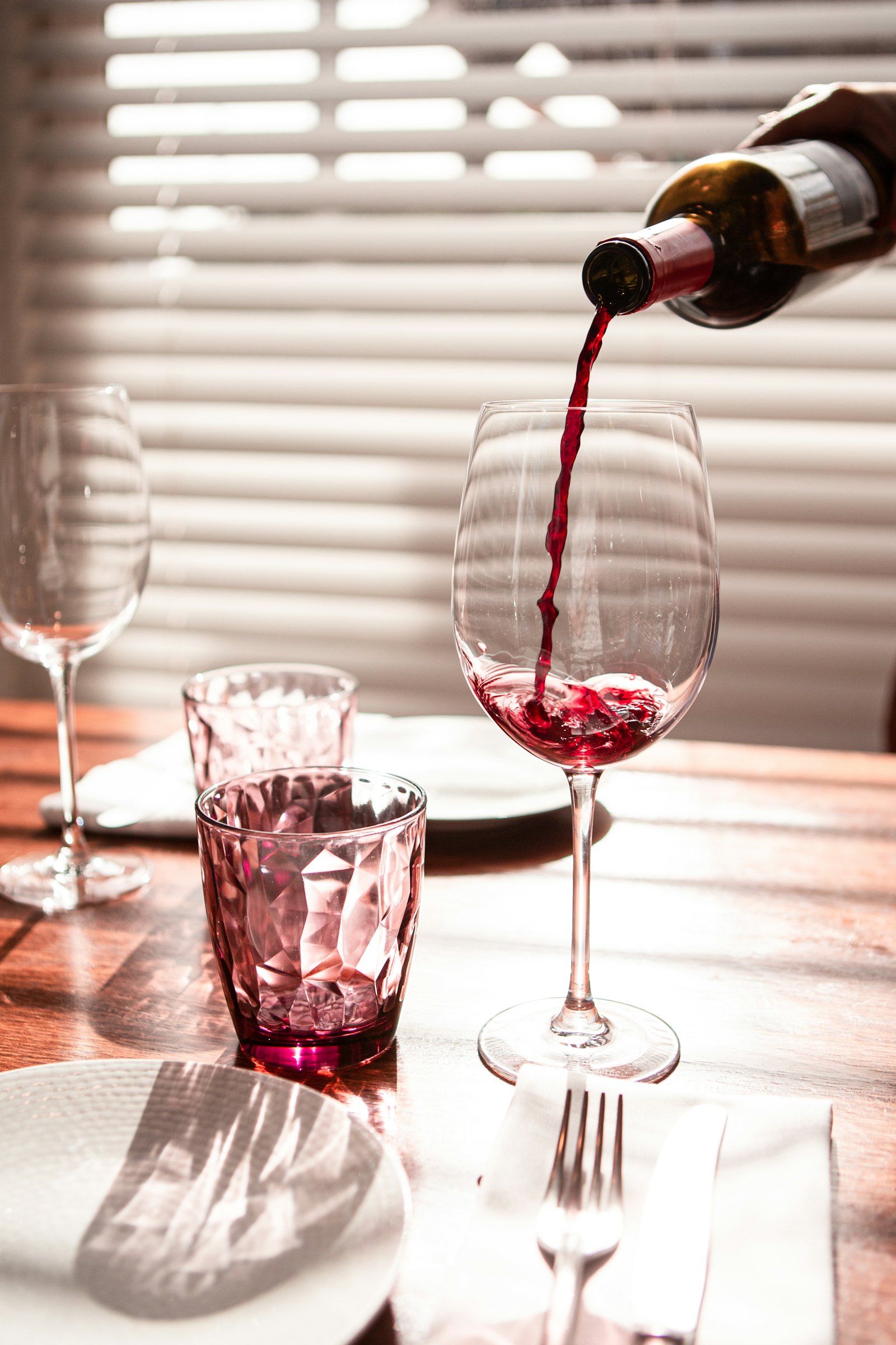 A glass of red wine being poured, representing the decision to stop drinking for financial and mental clarity